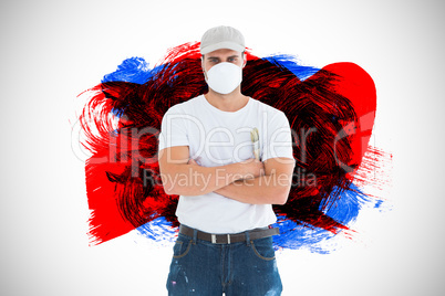 Composite image of man with paintbrush standing arms crossed by