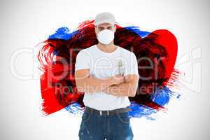 Composite image of man with paintbrush standing arms crossed by