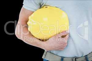 Composite image of technician holding hard hat