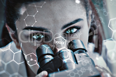 Composite image of close up of a scientist posing with a microsc