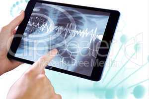 Composite image of man using tablet pc