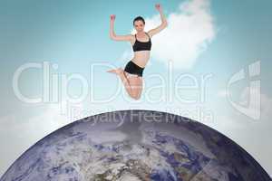 Composite image of full length of a sporty young woman jumping