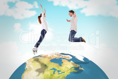 Composite image of couple jumping in the air