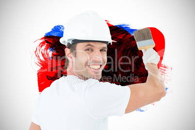 Composite image of portrait of happy man using paintbrush