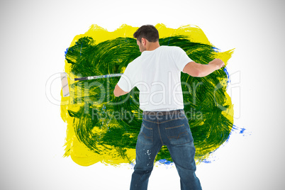 Composite image of man using paint roller on white background