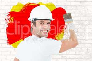 Composite image of portrait of happy man using paintbrush