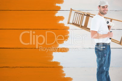 Composite image of man with paint roller and step ladder