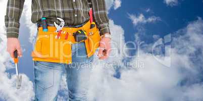 Composite image of manual worker holding hammer