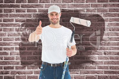 Composite image of happy man with paint roller gesturing thumbs up