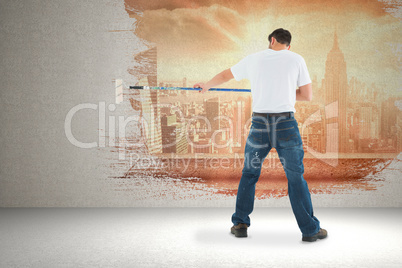 Composite image of man using paint roller on white background