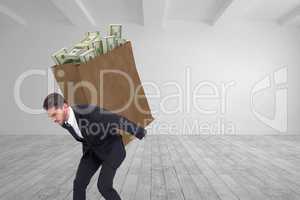 Composite image of businessman carrying something heavy with his