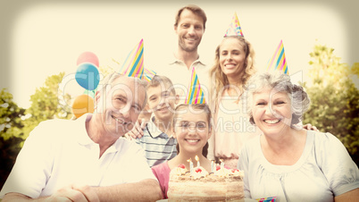 Cheeful family smiling at camera at birthday party
