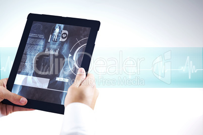 Composite image of man using tablet pc