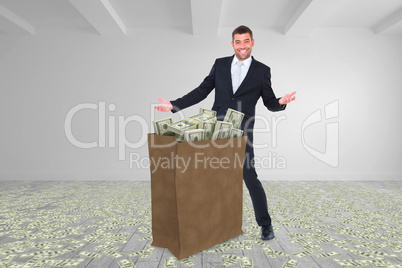 Composite image of businessman carrying bag of dollars