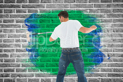 Composite image of man using paint roller on white background