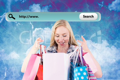 Composite image of pretty young blonde holding shopping bags