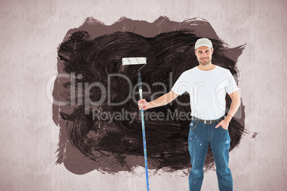 Composite image of confident man holding paint roller on white background