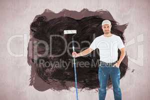 Composite image of confident man holding paint roller on white background