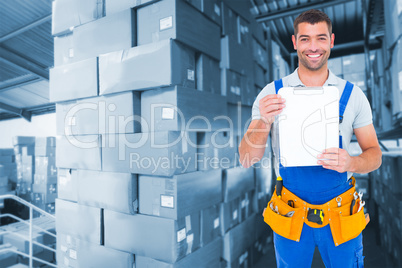 Composite image of portrait of happy repairman showing blank cli