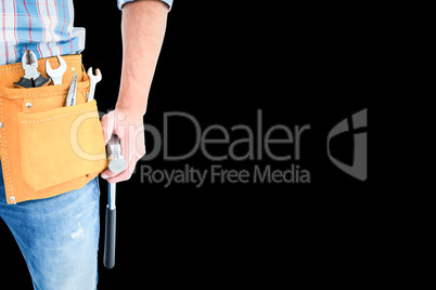 Composite image of handyman wearing tool belt while holding hamm