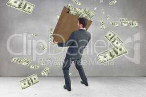 Composite image of businessman carrying bag of dollars