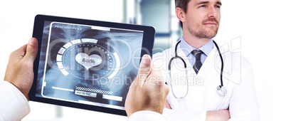 Composite image of man using tablet pc