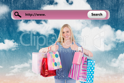 Composite image of pretty young blonde holding shopping bags