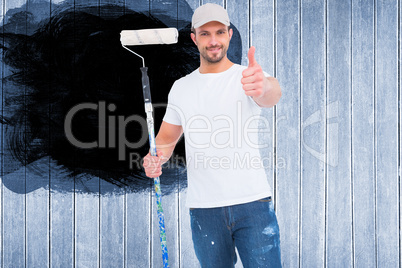 Composite image of handyman holding paint roller