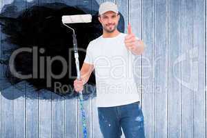 Composite image of handyman holding paint roller