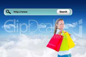 Composite image of smiling blonde holding shopping bags