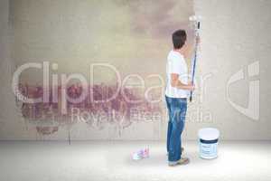 Composite image of man painting on white background