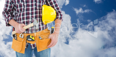 Composite image of repairman with hard hat and hammer