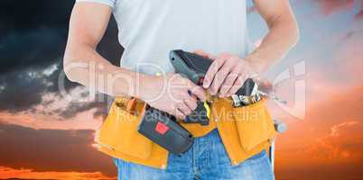 Composite image of repairman holding handheld drill