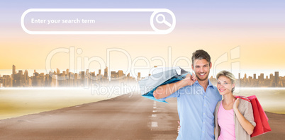 Composite image of attractive young couple holding shopping bags