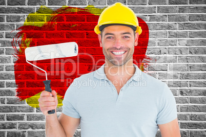 Composite image of portrait of manual worker holding paint roller