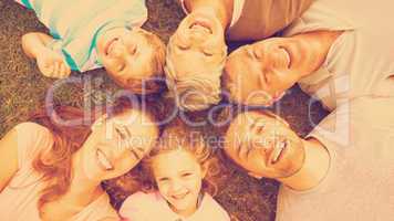 Extended family lying in circle at park