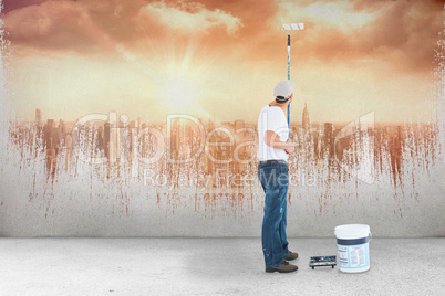 Composite image of man using paint roller on white background