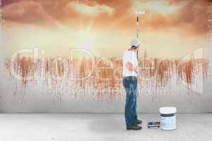 Composite image of man using paint roller on white background