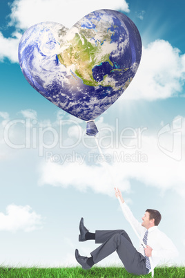 Composite image of businessman pulling a rope