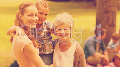 Grandmother mother and daughter with family in background at par