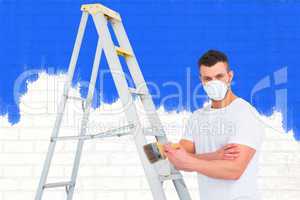 Composite image of handyman with paintbrush and ladder