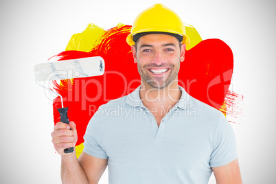 Composite image of portrait of manual worker holding paint rolle