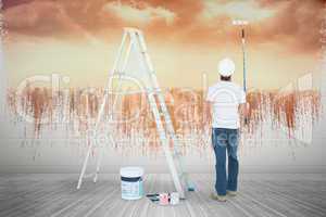 Composite image of man with paint roller standing by ladder