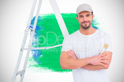 Composite image of handyman with paintbrush and ladder