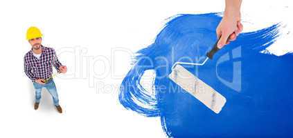 Composite image of handyman holding paint roller