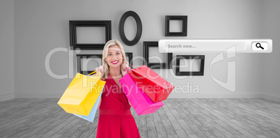 Composite image of stylish blonde in red dress holding shopping