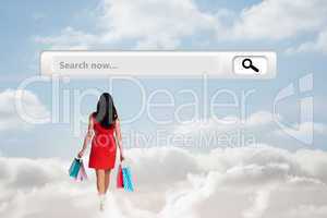 Composite image of woman standing with shopping bags