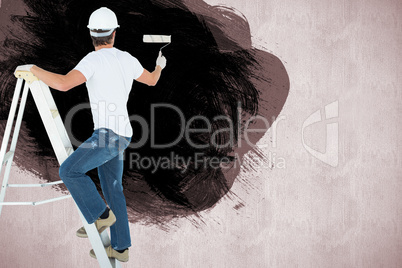 Composite image of man on ladder painting with roller