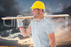 Composite image of worker with plank of wood