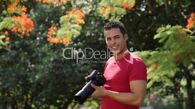 Portrait of happy man, amateur photographer smiling with camera